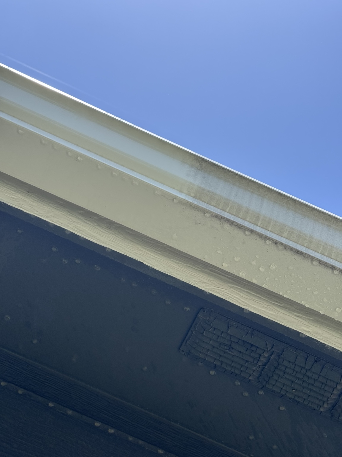 Close view of a residential gutter during exterior brightening work