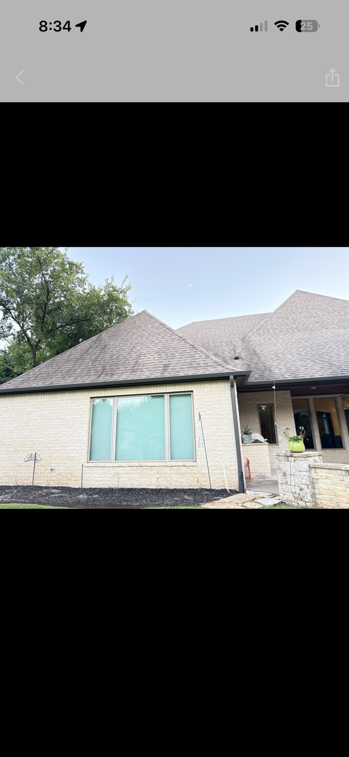 Dark organic streaks across a Tulsa-area asphalt-shingle roof