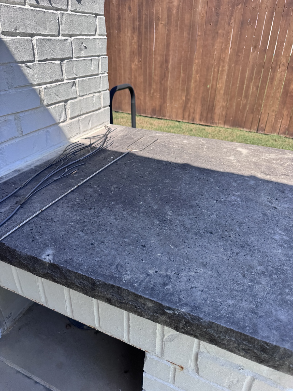 Darkened stone fireplace hearth before professional cleaning